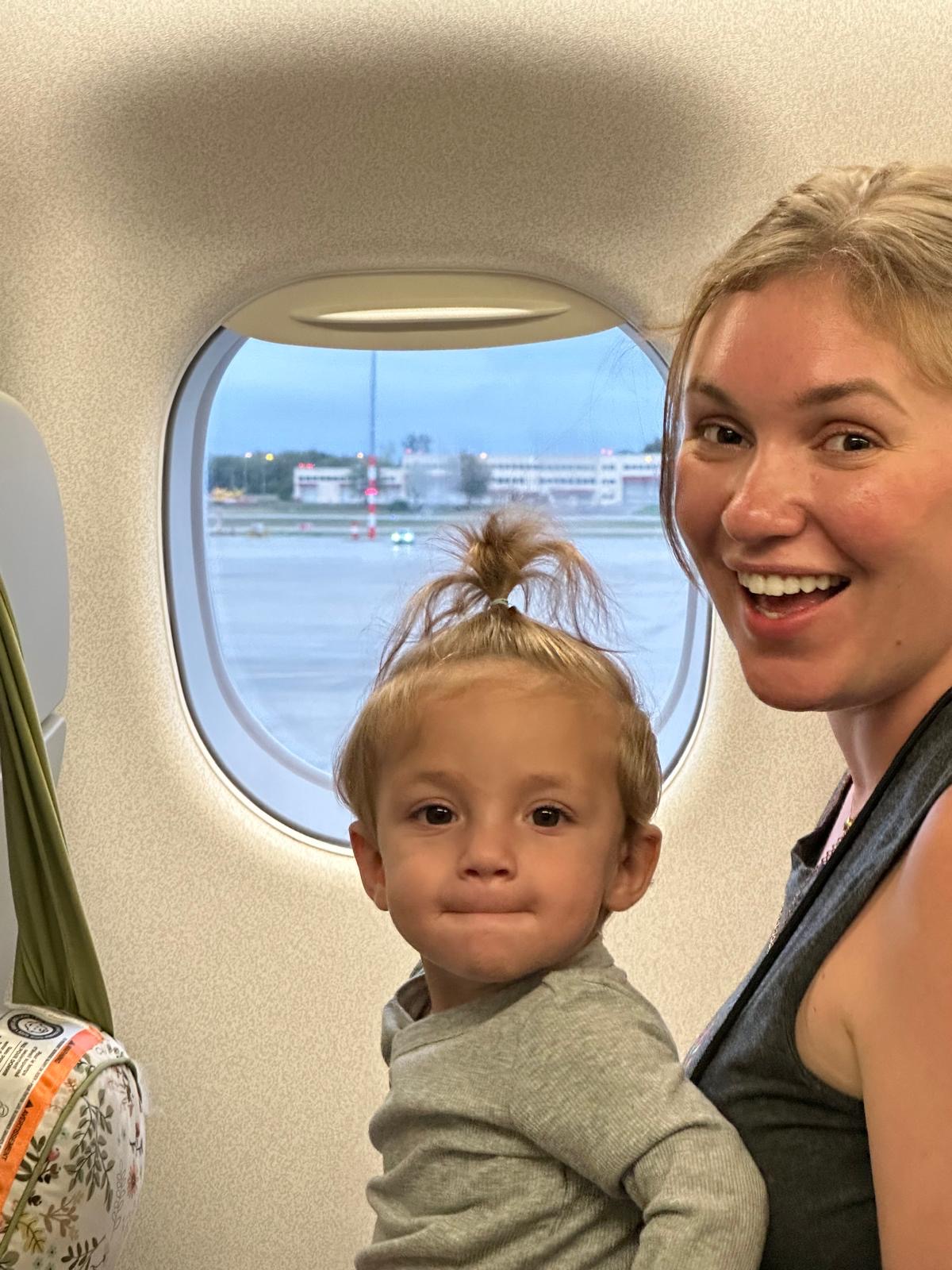 Mom and daughter at plane window